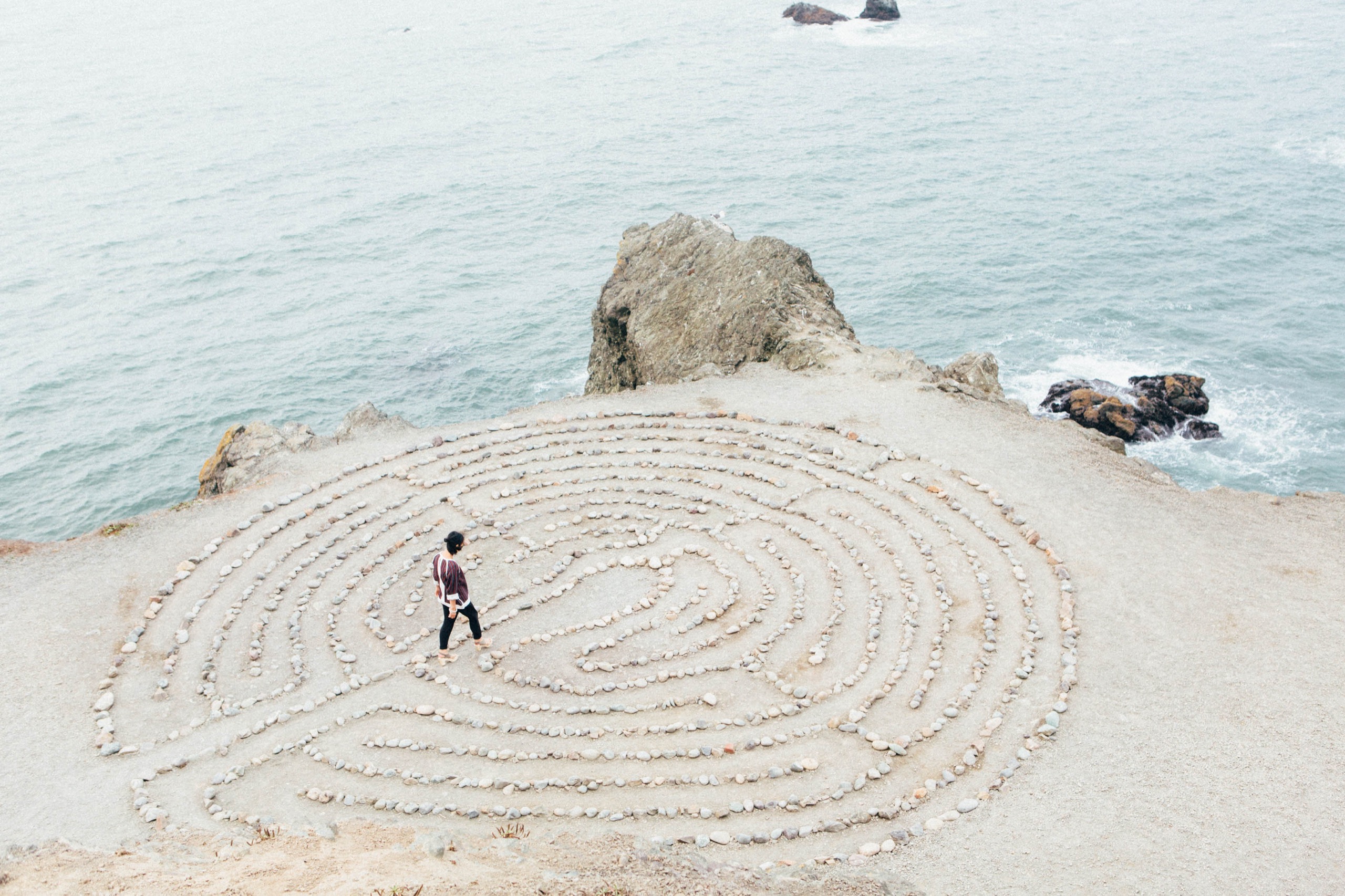 A spiral maze of stones laid out on open ground.